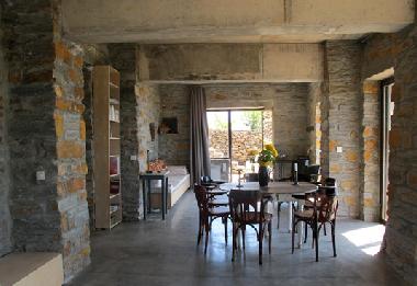 View looking out the entrance door to the large terrace and exterior eating and sitting area