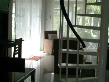 living room view with stairway going up to mezzanine