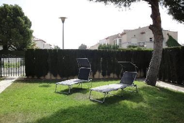 jardin avec chaises longues, parking pour voitures
